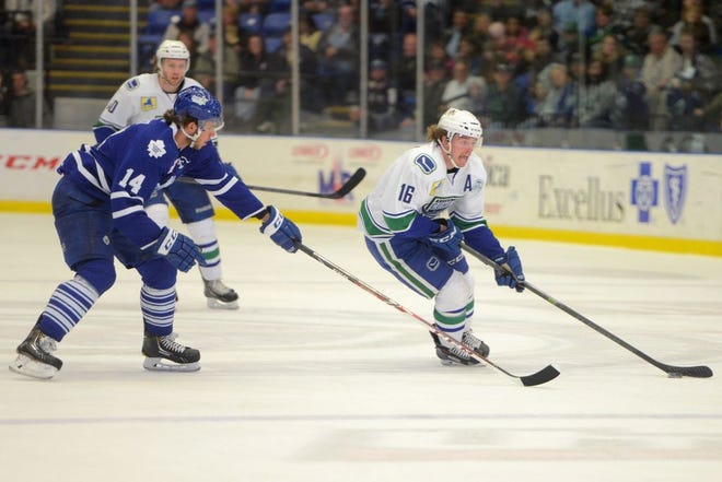 From left, Toronto Marlies player Josh Leivo defends as Utica Comets player Cal O'Reilly brings the puck down the ice during AHL hockey at the Utica Memorial Auditorium Friday, April 18, 2014.
