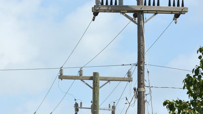 Florida Power & Light has dropped plans to strengthen a main transmission line, shown here on Bradley Place between Sunset and Sunrise avenues, at the town’s request.