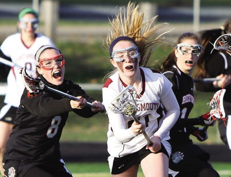 Portsmouth High School’s Lizzy Rice (center) battles through the defense of Bedford’s Meghan Lussier (left) and Sam Hornsby during Thursday’s Division II girls lacrosse game in Portsmouth. The Clippers lost 22-14.