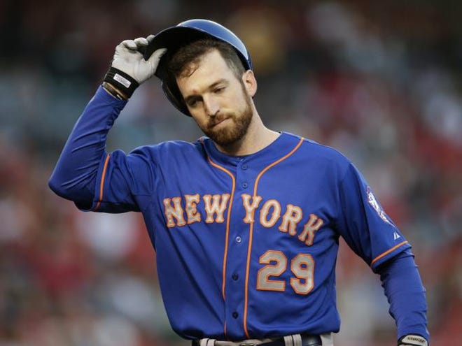 New York Mets' Ike Davis takes off his helmet after he flied out during the fourth inning of a baseball game against the Los Angeles Angels on Saturday, April 12, 2014, in Anaheim, Calif.