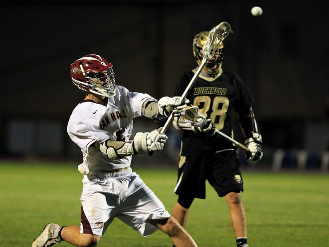 Oak Hall's Tyler Baggett (15) fires a shot for one of his three goals during the Eagles' 15-5 win over Buchholz in the District 2 title game at home on Friday.