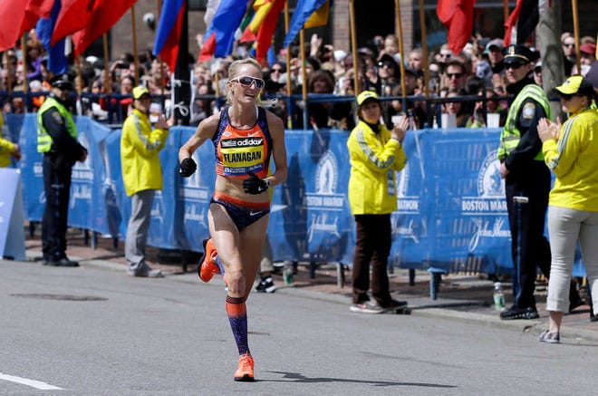 FILE - In this April 15, 2013, file photo, Shalane Flanagan approaches the finish line to finish fourth in the women's division of the Boston Marathon in Boston. Flanagan is more determined than ever to win the race for her battered hometown. The Marblehead, Mass., native would be the first American winner since 1985. (AP Photo/Elise Amendola, File)