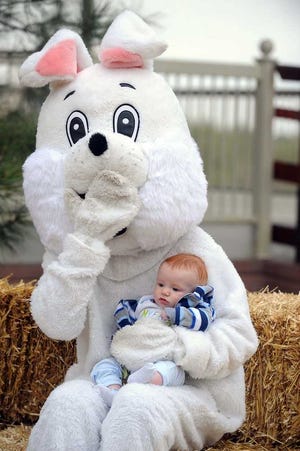 Brooks Ellison, 5 months, sits on the lap of the Easter Bunny at Amarillo Zoo's Easter Egg-citement event.
