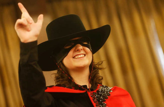 Incoming Masked Rider Mackenzie White gives a Guns Up during the Transfer of the Reins ceremony at the McKenzie-Merket Alumni Center. She is the 53rd Masked Rider, taking the place of Corey Waggoner.