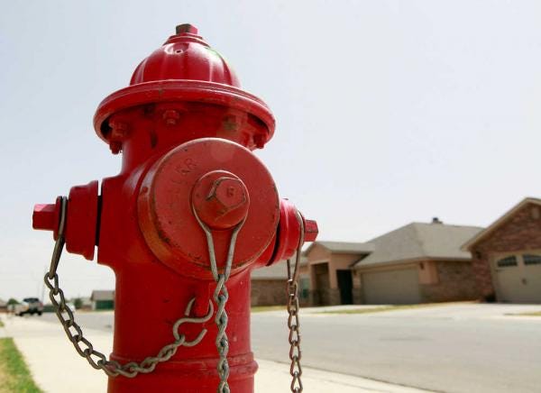 A fire hydrant sits at the corner of 90th St. and Quitman Ave. A monthly flush to check a line's chlorine level takes about 15 minutes and uses roughly 17,500 gallons of water, unless a second 15-minute flush is required.