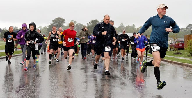 Runners take off from the start line at the annual St. Jude Race Saturday in Havelock. Despite the heavy rain, most of the 180 registered participants came out to run and walk to raise money for the children's cancer treatment and research hospital.