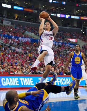 Los Angeles' Blake Griffin puts up a shot after fouling Golden State's Marreese Speights Saturday during the Warriors' 109-105 win in the first game of their playoff series. THE ASSOCIATED PRESS
