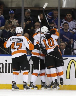 Philadelphia Flyers defenseman Andrew MacDonald (47), defenseman Mark Streit, and (32) of Switzerland and Flyers center Brayden Schenn (10) celebrate after center Jason Akeson scored the tying goal in the second period of Game 2 of the first round of the Stanley Cup hockey playoffs at Madison Square Garden in New York, Sunday, April 20, 2014. The Flyers defeated the Rangers 4-2. (AP Photo/Kathy Willens)