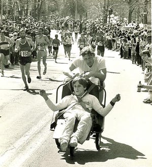Dick and Ricky Hoyt heading up Heartbreak Hill in Newton in the 1980s.

Daily News Staff Photo / Art Illman