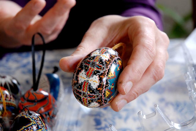 Tina Brand shows one of her pysanka (decorated Ukrainian egg), on which she intentionally used no straight lines. Wicked Local Staff Photo/Ami Olson