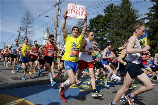 Runners in the first wave of 9,000 cross the start line of the 118th Boston Marathon Monday, April 21, 2014 in Hopkinton, Mass. (AP Photo/Stephan Savoia)