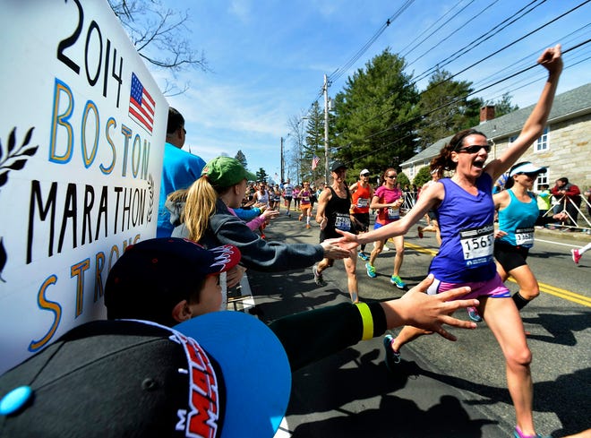 Kim Mendell of Natick cheers as she surges out of Hopkinton at the start of the 2014 Boston Marathon Monday morning.

Daily News Staff Photo / Allan Jung