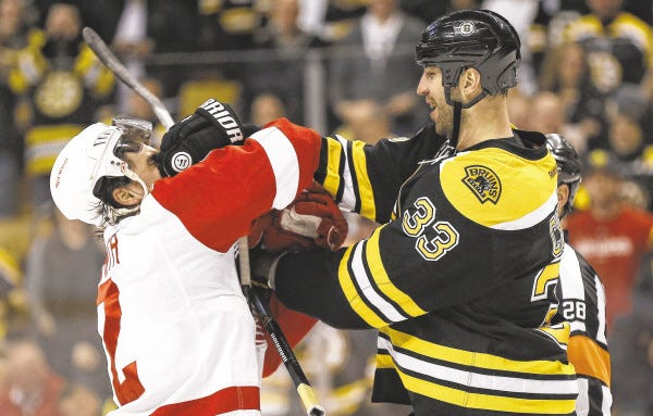 The Bruins' Zdeno Chara mixes it up with the Red Wings' Brendan Smith during the first period of Game 2 in Boston on Sunday. Boston bounced back from a Game 1 loss to win 4-1.