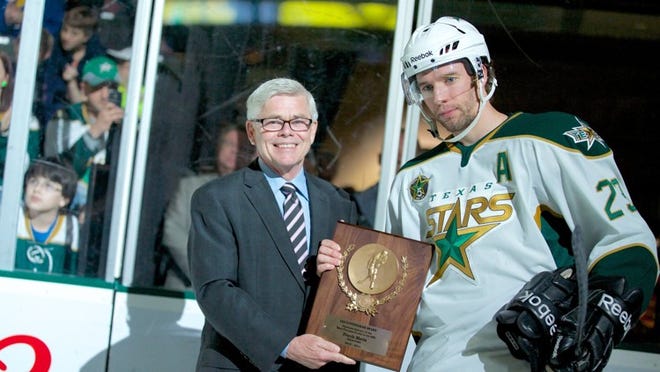 American Hockey League President David Andrews presents the AHL’s most valuable player award to Texas Stars center Travis Morin on Saturday. During a stop at Cedar Park Center last weekend, Andrews watched the Stars play the Abbotsford Heat and discussed the possibility of franchise realignment within the AHL. CREDIT: Texas Stars