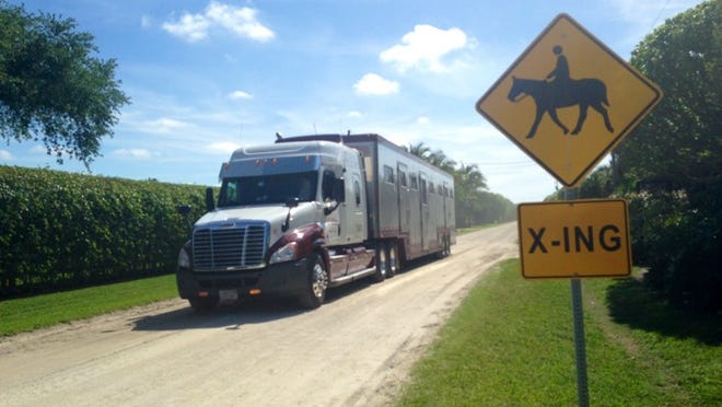 A horse trailer kicks up dust as it drives down Appaloosa Trail in Wellington’s southern Saddle Trail neighborhood on Monday, April 21, 2014. The community is one of only a few left in the village with unpaved roads. (Kristen M. Daum / The Palm Beach Post)