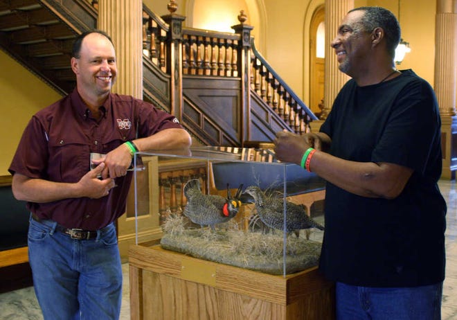 Rob Robinson, left, of Starkville, Miss., chats with Gil Alexander, of Nicodemus, Kan., at a prairie chicken display Tuesday at the Statehouse in Topeka. Robinson and Alexander are avid outdoorsmen who have developed a friendship and business partnership after Robinson donated a kidney to Alexander in 2012.