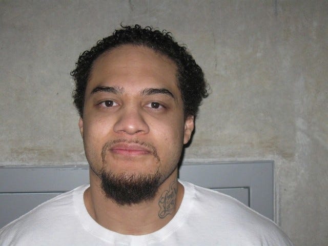 This Feburary 2012 photo, provided by the Utah Department of Corrections, shows Siale Angilau. A U.S. marshal shot and critically wounded Angilau on Monday, April 21, 2014, in a new federal courthouse after he rushed the witness stand with a pen at his trial in Salt Lake City, authorities said. Angilau was one of 17 people named in a 29-count racketeering indictment filed in 2008 accusing gang members of conspiracy, assault, robbery and weapons offenses. (AP Photo/Utah Department of Corrections) 
 Police tape surrounds the Federal Courthouse Monday, April 21, 2014, in Salt Lake City. A U.S. marshal shot and critically wounded a defendant on Monday in a new federal courthouse after the man rushed the witness stand with a pen at his trial in Salt Lake City, authorities said. (AP Photo/Rick Bowmer) 
 Members of the FBI evidence response team enter the Federal Courthouse, Monday, April 21, 2014, in Salt Lake City. A U.S. marshal shot and critically wounded a defendant on Monday in a new federal courthouse after the man rushed the witness stand with a pen at his trial in Salt Lake City, authorities said. Defendant Siale Angilau was hospitalized with at least one chest wound, FBI spokesman Mark Dressen said. The witness wasn't hurt. Angilau was one of 17 people named in a 29-count racketeering indictment filed in 2008 accusing gang members of conspiracy, assault, robbery and weapons offenses. (AP Photo/Rick Bowmer)