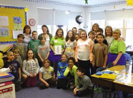 Students and teachers at Coastal Ridge Elementary School pose with Nana’s Kids owner Donna Green and her granddaughter Jessica Lee, the latter in blue tutu’s to commemorate April and “Light It Up Blue” during Autism Awareness Month.