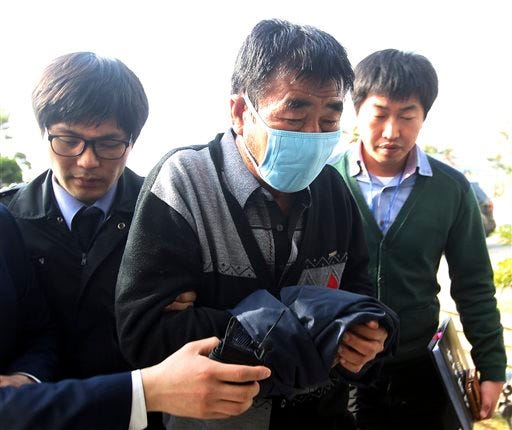 Lee Joon-seok, center, the captain of the sunken ferry boat Sewol in the water off the southern coast, arrives at the headquarters of a joint investigation team of prosecutors and police in Mokpo, south of Seoul, South Korea. A colleague calls Capt. Lee Joon-seok the nicest person on the ship. Yet there he was, captured in video on the day his ferry sank with hundreds trapped inside, being treated onshore after allegedly landing on one of the first rescue boats.