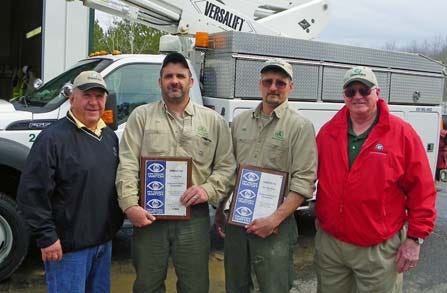 Lineworkers Jim Sutton and Phil Den Boer with Cloverland District C Directors Ron Provo and Virgil Monroe.