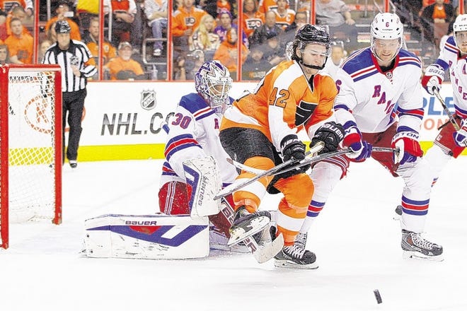 Flyers' Jason Akeson, center, goes after the puck while being flanked by Rangers goalie Henrik Lundqvist, left, and Anton Stralman.