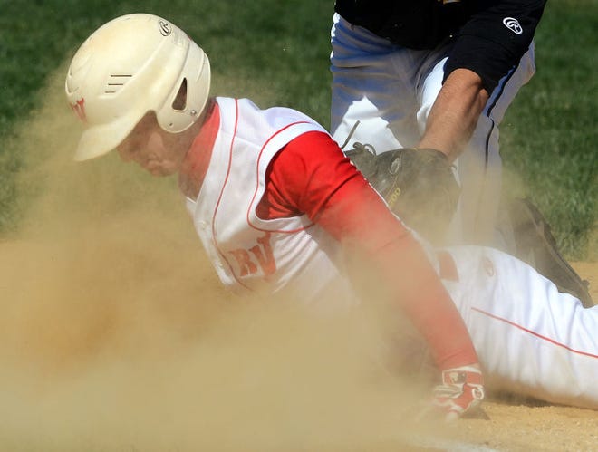 First inning action had Rancocas Valley's 7 Matt Horton gets a face full of sand as he beats Moorestown's 8-Justin Varga's tag back at first.