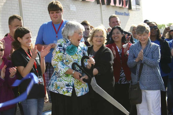 Lynn Elms cuts a Chamber of Commerce ribbon to officially open Goodwill's Elms Learning Center, 714 34th St.