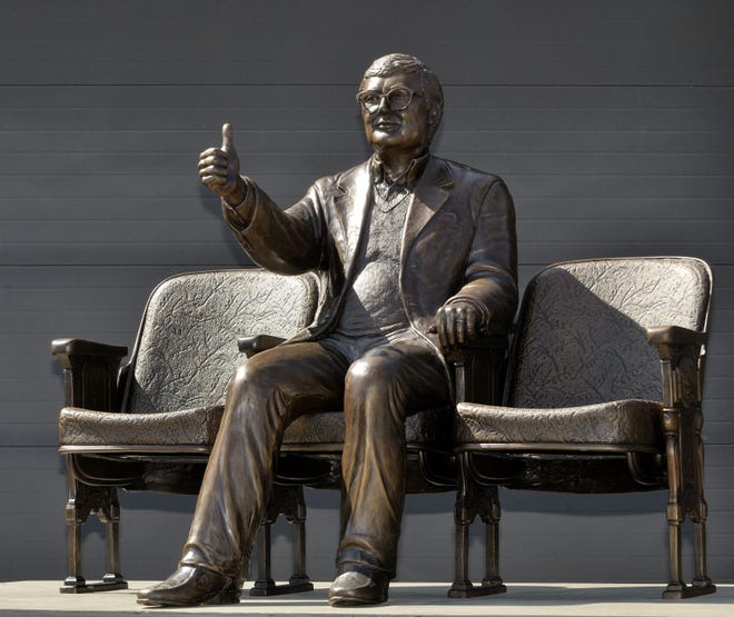A bronze statue of Pulitzer Prize winning film critic Roger Ebert giving his famous ‘thumbs up” sign in Champaign, Ill. The statue was unveiled Thursday, April 24, 2014, outside the Virginia Theatre in Champaign where Ebert held his annual film festival. Ebert died in April 2013.