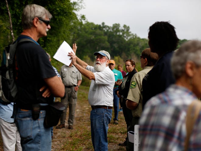 Bob Simons, at center, leads a tour of his tree farm during the Longleaf Pine Forest Stewardship Workshop on Thursday.