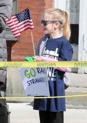 Katie Byrne, 8, of Wayland, waits for runners in Natick. WICKED LOCAL PHOTO / JOHN THORNTON