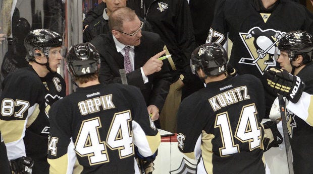 Penguins coach Dan Bylsma talks to players during a Columbus timeout in the third period of the Pittsburgh Penguins' first-round playoff against the Columbus Blue Jackets on Wednesday, April 16, 2014, at Consol Energy Center in Pittsburgh.