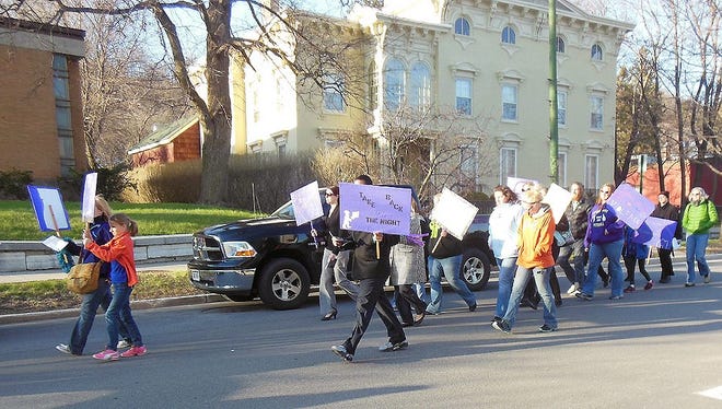 Marchers chant slogans as they walk down Main Street in Little Falls during Thursday’s Take Back the Night rally. TELEGRAM PHOTO/DONNA THOMPSON