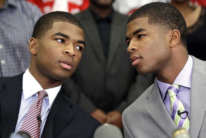 David J. Phillip Associated Press Twins Aaron (left) and Andrew Harrison (right) have decided to return to the University of Kentucky next year. "We still have unfinished business," said Aaron Harrison.