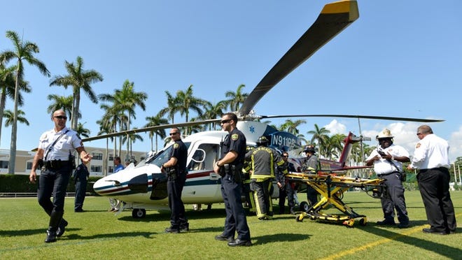 Police officers and firefighters receive training on Trauma Hawk procedures Thursday at the Palm Beach Recreation Center field.