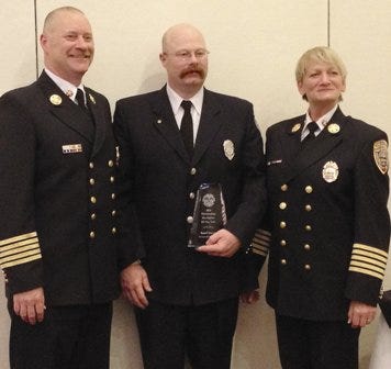 From left, Portsmouth Fire Chief Steven Achilles, firefighter Russell Osgood and Deborah Pendergast, director of the N.H. Fire Academy. Osgood was awarded the Firefighter’s Award of the Year by the New Hampshire Police, Fire and EMS Foundation.