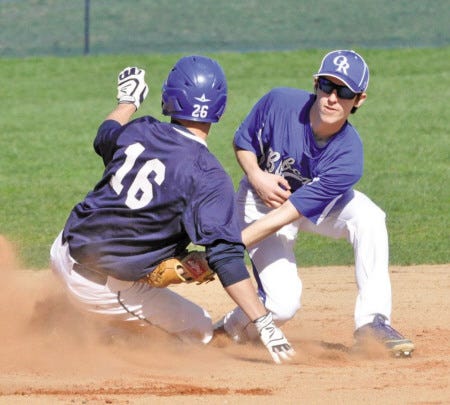 Mike Whaley/foster’s daily Democrat
Oyster River High School’s Aidan Short (right) tags out St. Thomas baserunner Ryan Bennett trying to steal second base during Division II baseball action Thursday in Dover. The Bobcats beat the Saints, 9-6.