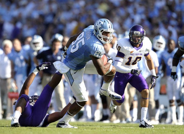 FILE - In this Sept. 22, 2012 file photo, North Carolina's Eric Ebron (85) breaks a tackle against East Carolina defenders during the first half of an NCAA college football game in Chapel Hill, N.C. Second-year coach Larry Fedora wants more, talking openly of his goal for Ebron to score a dozen touchdowns in a season that starts with Thursday's, Aug. 29, 2013, trip to No. 6 South Carolina. (AP Photo/Gerry Broome, File)