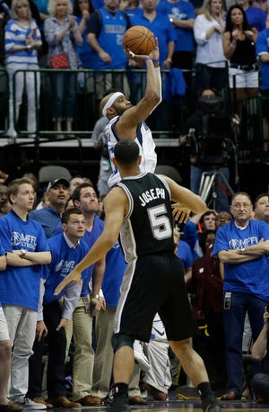 Dallas Mavericks guard Vince Carter, top, shoots the game-winning 3-point basket at the buzzer over San Antonio Spurs guard Cory Joseph (5) in the fourth quarter of Game 3 in the first round of the NBA basketball playoffsin Dallas, Saturday, April 26, 2014. The Mavericks won 109-108. (AP Photo/LM Otero)