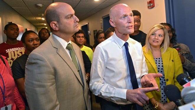 Florida Gov. Rick Scott, center, should take the lead in reforming Bright Futures, one of the most valuable education incentives we have when it comes to building the skilled and talented workforce needed for Florida’s future economy. (AP Photo/The Florida Times-Union, Bob Mack)