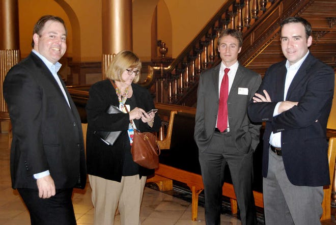 Parallel Strategies lobbyist David Kensinger, left, and partner Riley Scott, right, huddle in the Capitol during the 2014 legislative session with clients Mary Sloan and Ben Jones, who are with the Coalition Against the Death Penalty. The FBI is looking into Parallel Strategies.