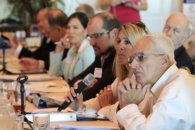 Startup Quest judges, from right, Paul Manning, Carol Craig, Mark Patten and others on the panel listen to pitches during the inaugural entrepreneurial event last August at SW Grille in Daytona Beach.