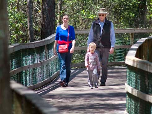 A family walks recently at Turkey Creek Park in Niceville.