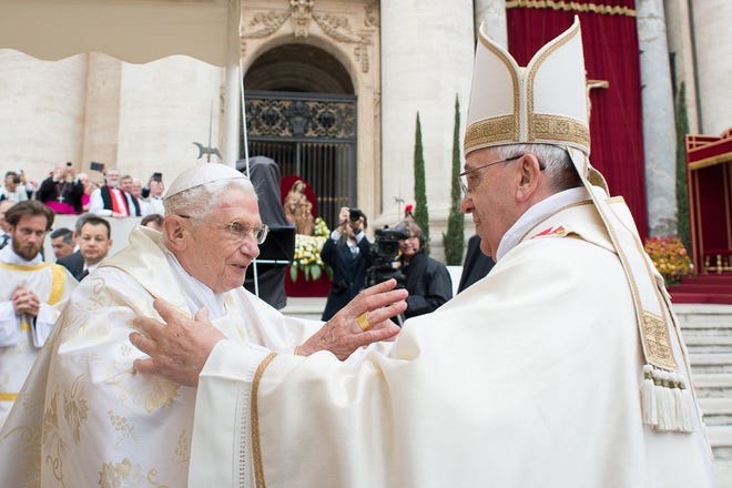 Pope Francis, right, embraces his predecessor, Pope Emeritus Benedict XVI, Sunday in St. Peter’s Square at the Vatican. Pope Francis has declared John XXIII and John Paul II saints in an unprecedented canonization ceremony.