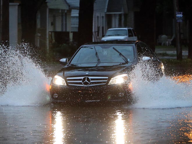 In this image from June 2013, a motorist crosses 12th Street at Eighth Avenue during a rainstorm in Tuscaloosa.