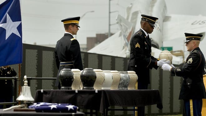 Staff Sgt. Tyler Blaise brings an urn with ashes to Sgt. Jonathan Strother during the ceremony.