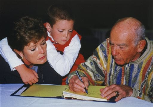 In this Oct. 12, 2000, file photo, provided by the University of Tennessee, Tyler Summitt, center, holds onto his mother, Tennessee women's basketball coach Pat Summitt, as she talks with former NBA coach Jack Ramsay at the Basketball Hall of Fame in Springfield, Mass. Ramsay, a Hall of Fame coach who led the Portland Trail Blazers to the 1977 NBA championship has died following a long battle with cancer.