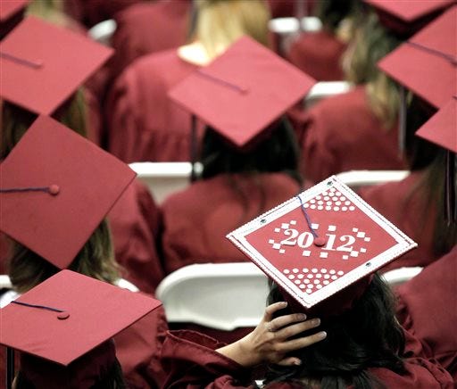 Graduates from Joplin High School listen to speakers during commencement ceremonies in Joplin, Mo., in 2012. U.S. public high schools have reached a milestone, an 80 percent graduation rate.