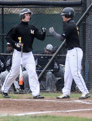 Moorestown's Dallas Clark (7) celebrates with Justin Varga (8) after scoring against Burlington Township during Tuesday afternoon's baseball game at Burlington Township High School.