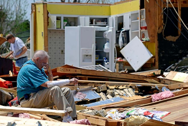 Charles Milam takes a break while searching his destroyed home on Clayton Avenue in Tupelo, Miss., Tuesday, April 29, 2014. Milam, his wife and his granddaughter were at home at the time of the tornado, and all survived. A dangerous storm system that spawned a chain of deadly tornadoes over three days flattened homes and businesses, forced frightened residents in more than half a dozen states to take cover and left tens of thousands in the dark Tuesday morning.(AP Photo/Thomas Graning)
