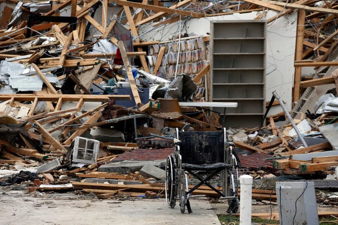 A wheelchair sits outside a tornado destroyed medical office in south Louisville, Miss., Tuesday, April 29, 2014. Numerous businesses, residences and the community hospital were destroyed or heavily damaged after a tornado hit the east Mississippi community Monday. Louisville is the county seat and home to about 6,600 people. (AP Photo/Rogelio V. Solis)